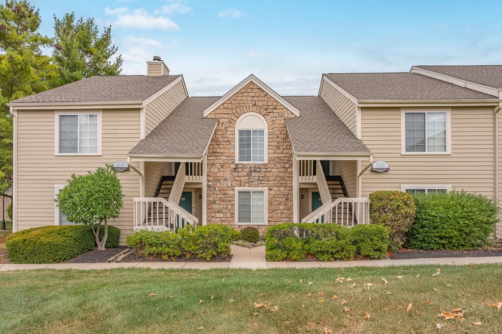 A house with a stone facade and a large front porch.