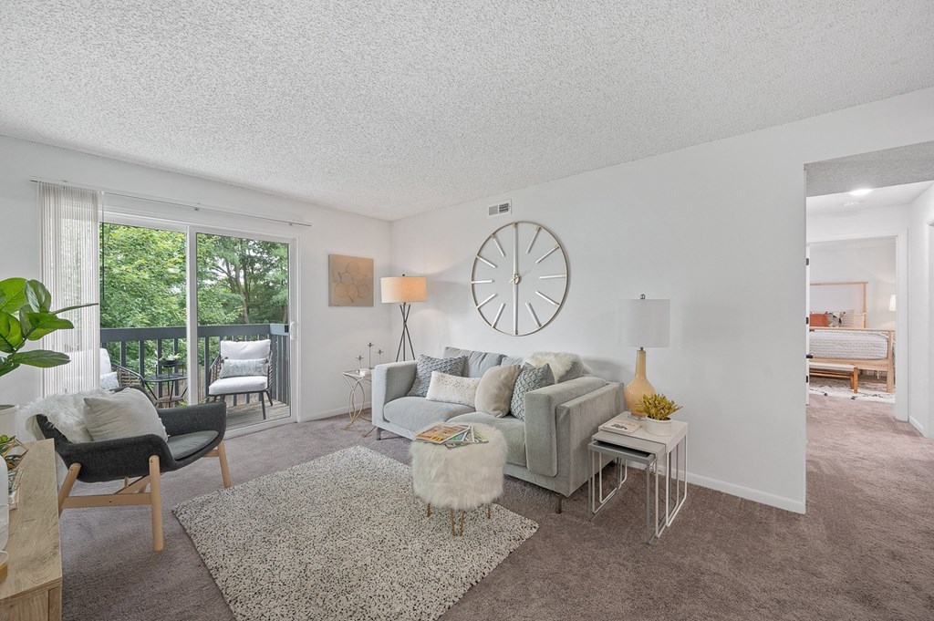 Living room with white walls and a gray couch  at Timber Glen Apartments, Batavia, Ohio