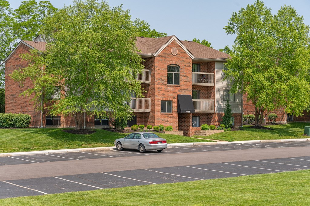 a car parked in front of an apartment building