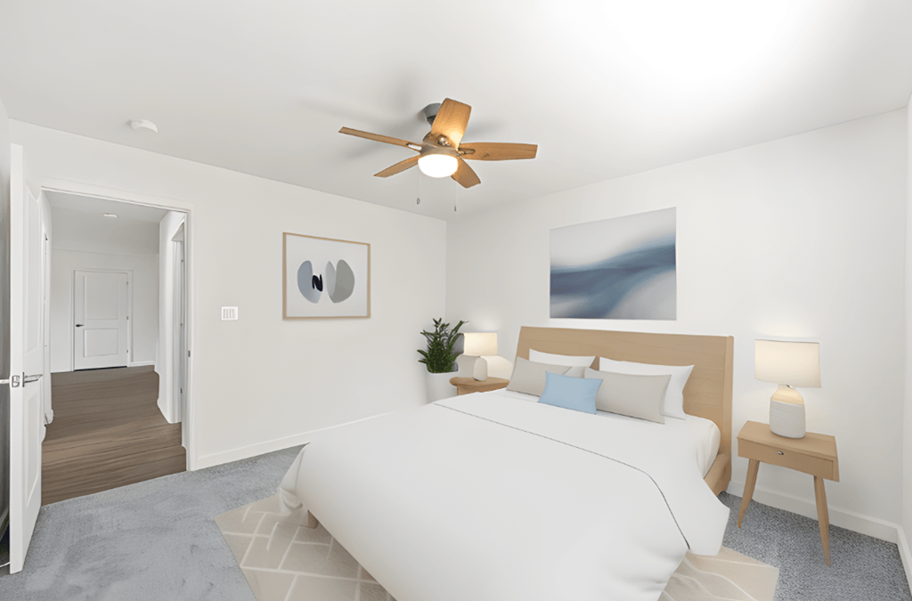 a bedroom with a large white bed and a ceiling fan