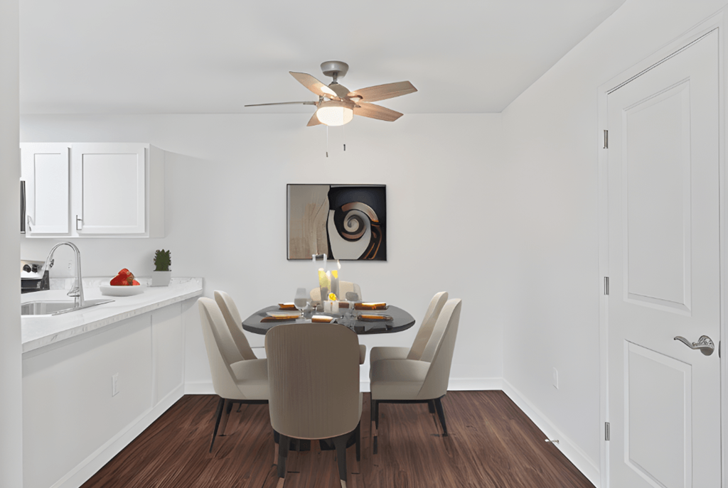 a dining room with a table and chairs and a ceiling fan