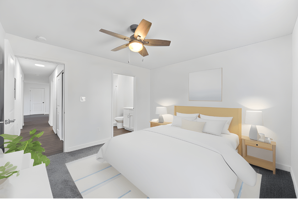 a white bedroom with a large bed and a ceiling fan