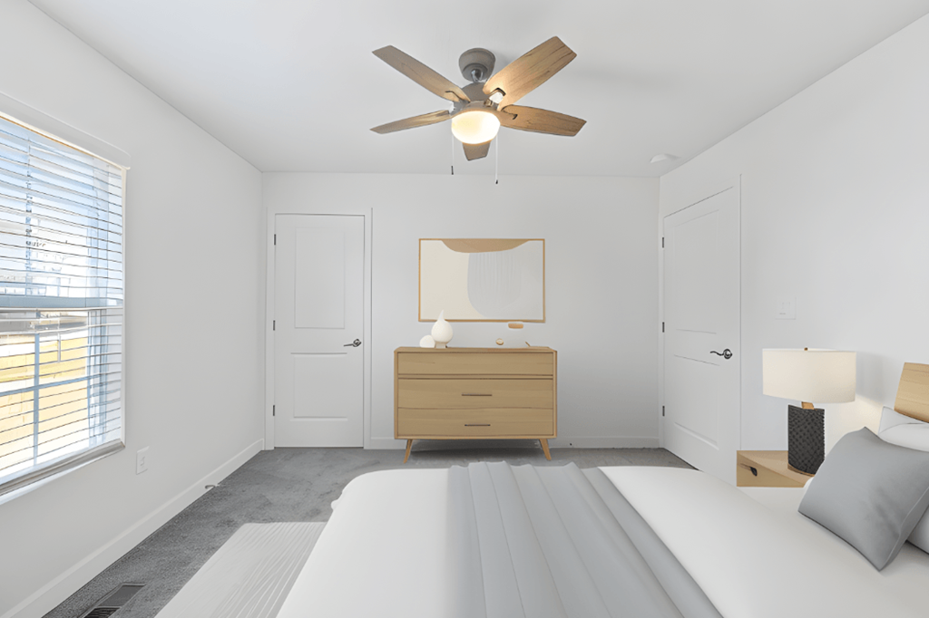 a white bedroom with a bed and a ceiling fan