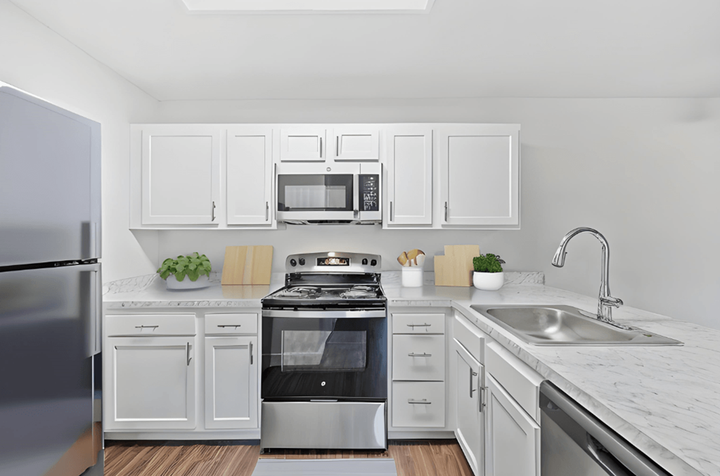 a kitchen with white cabinets and stainless steel appliances