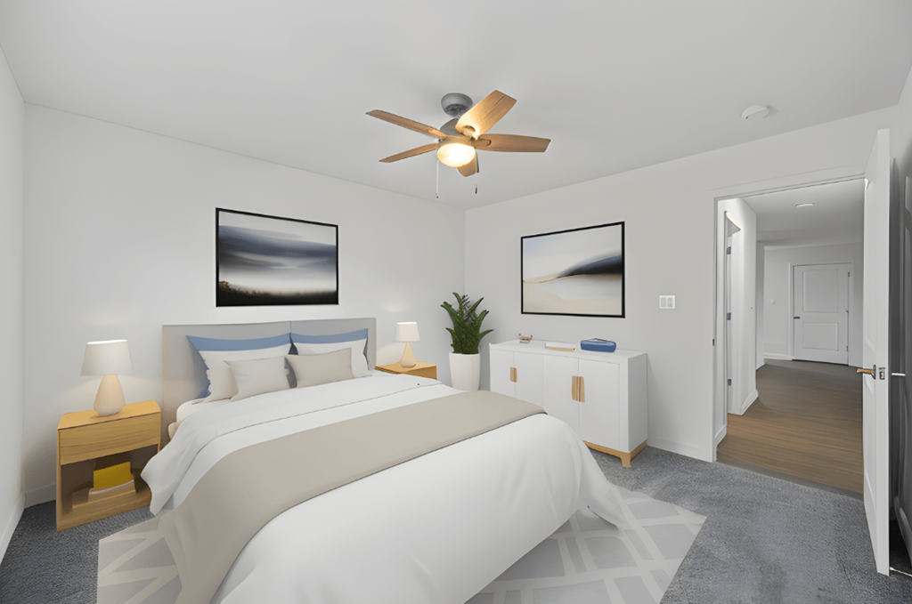 a white bedroom with a large bed and a ceiling fan