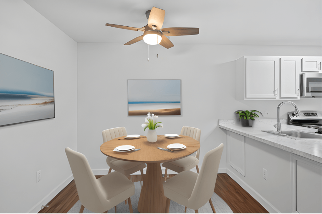 a kitchen and dining room with a table and chairs and a ceiling fan