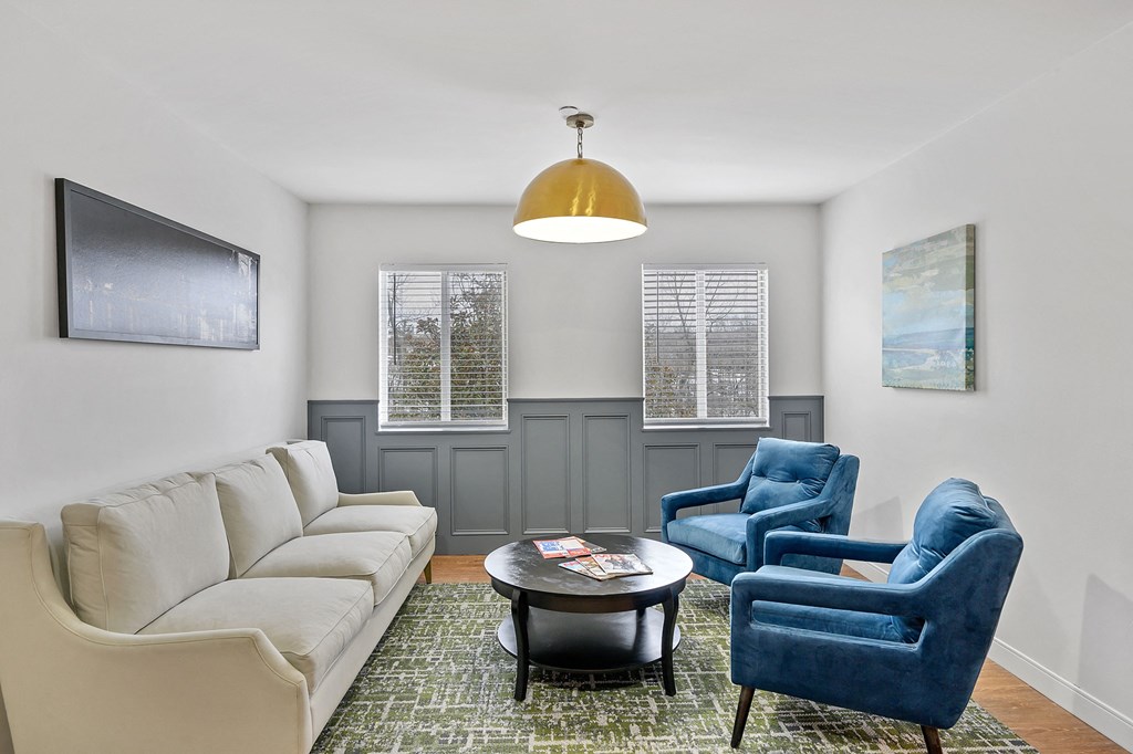 Living room with a white couch and two blue chairs at The Valley, Cincinnati, Ohio