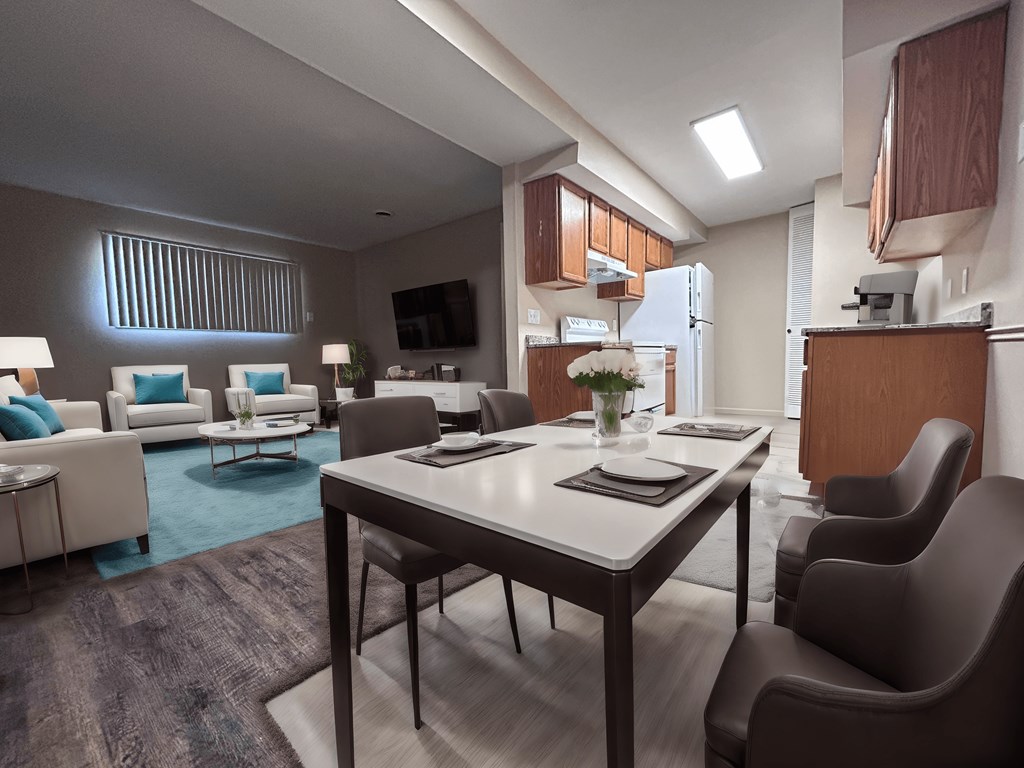 a living room and kitchen with a table and chairs