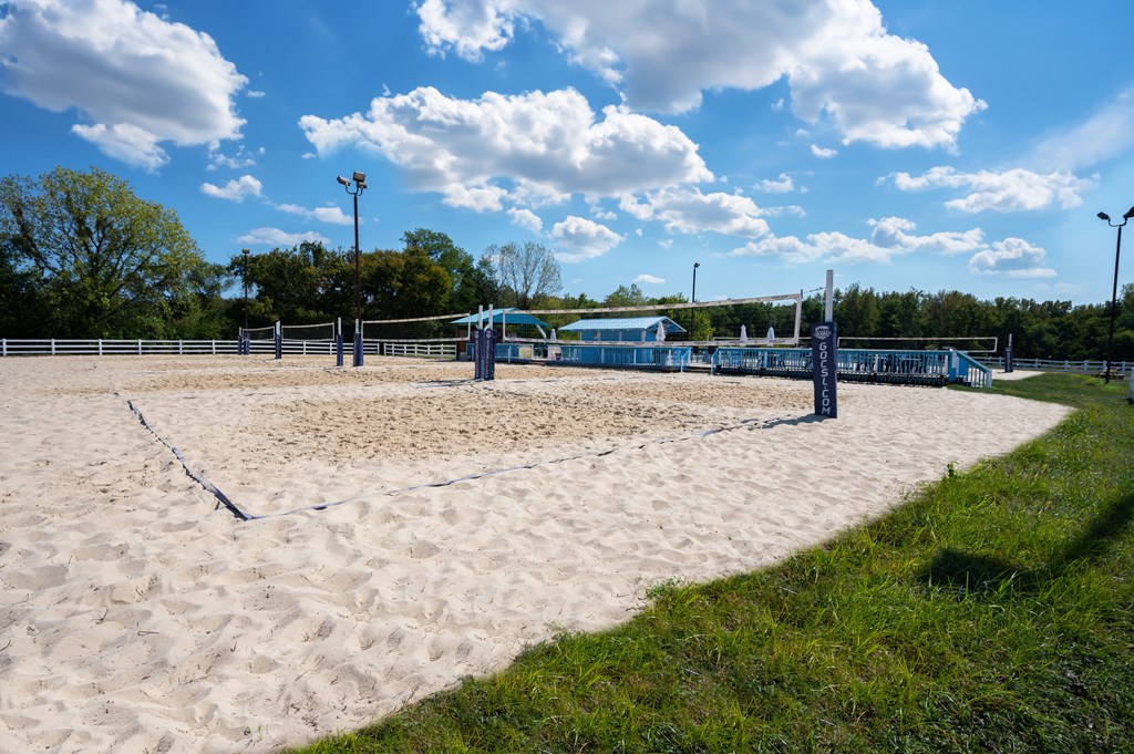 a sand volleyball court at a park on a sunny day