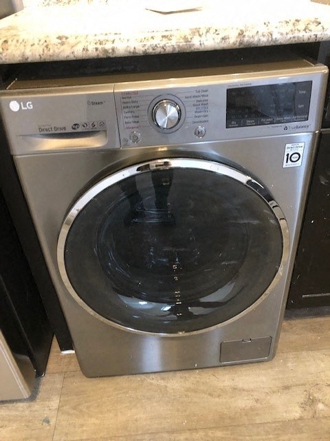 a stainless steel washing machine in a kitchen