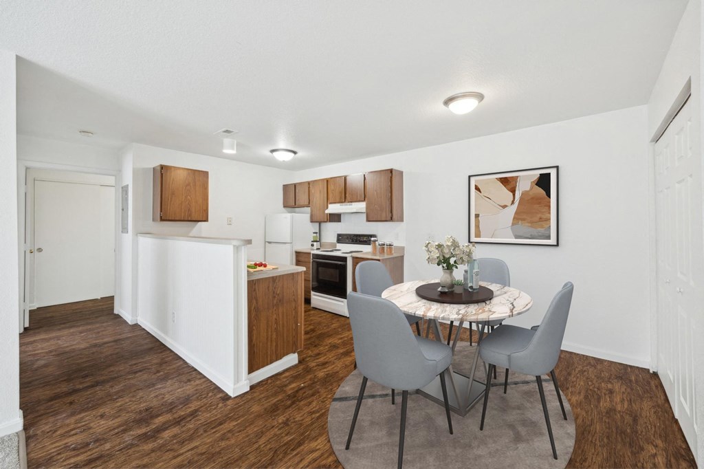 A kitchen with a table and chairs in the middle of the room.