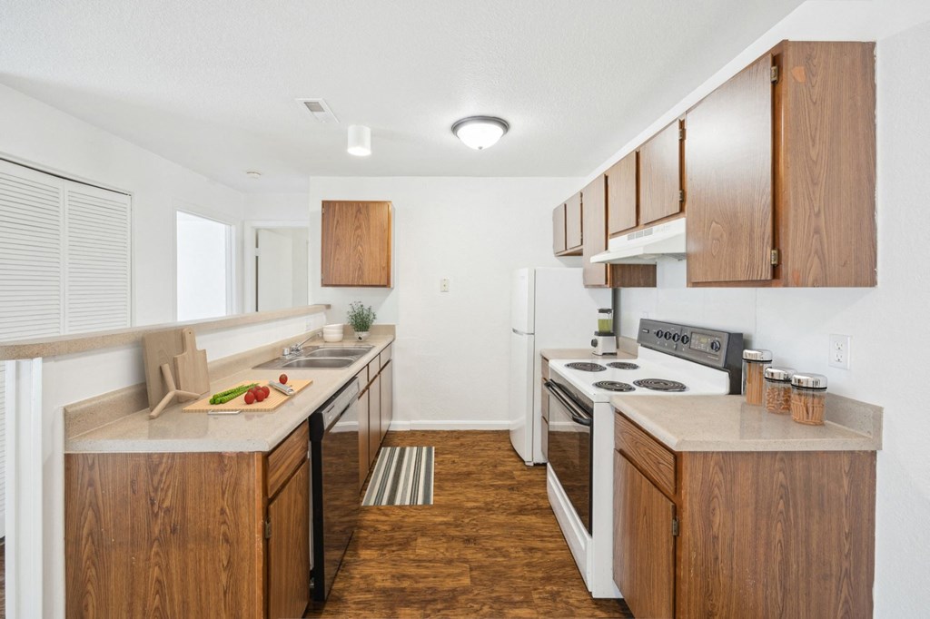 A kitchen with wooden cabinets and a white refrigerator.