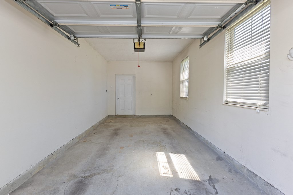 the inside of an empty room with a door and window