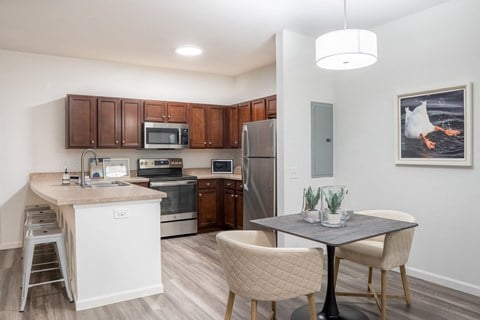 a kitchen and dining area in a 555 waverly unit  at Waterstone Landing, Perrysburg, OH, 43551
