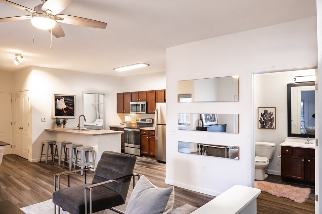 a living room with a couch and a chair and a kitchen with a sink and a toilet at Waterstone Landing, Perrysburg