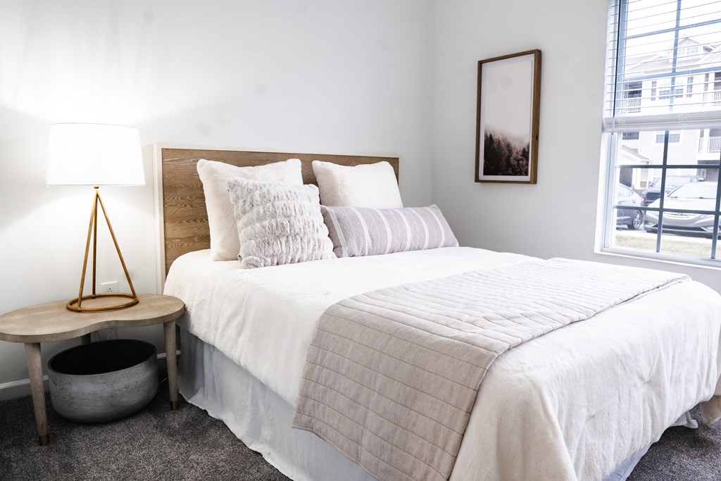 a bedroom with a bed and a window  at Waterstone Landing, Ohio
