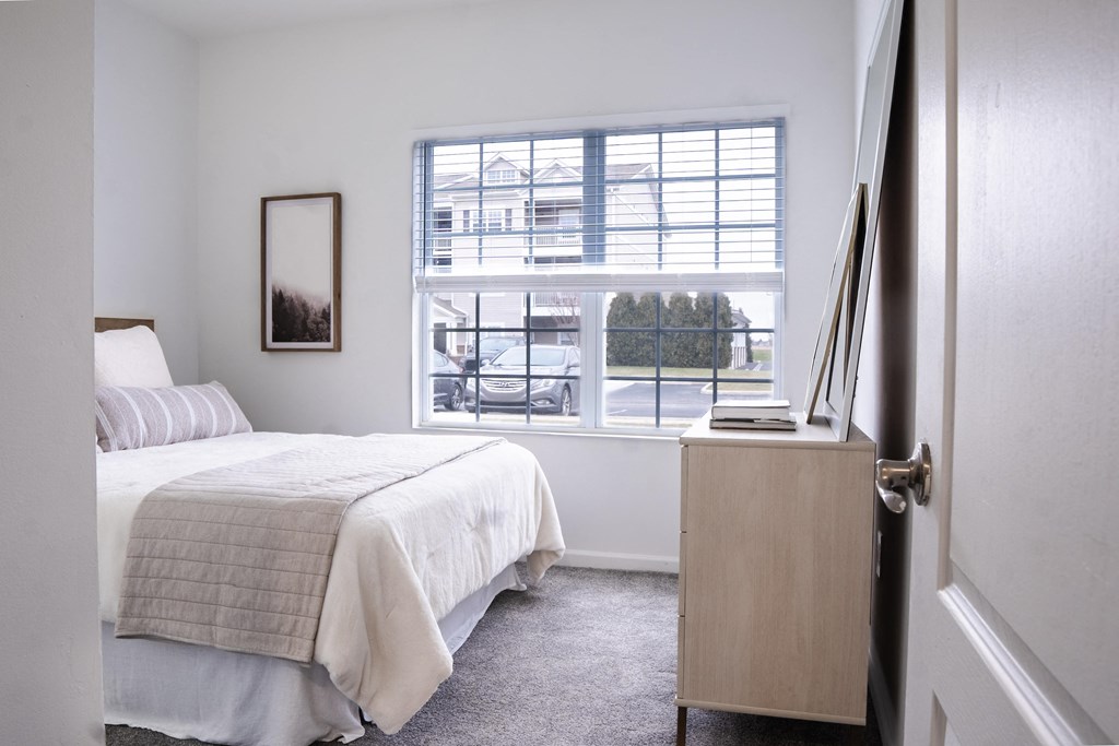 a bedroom with a bed and a large window at Waterstone Landing, Perrysburg, OH, 43551