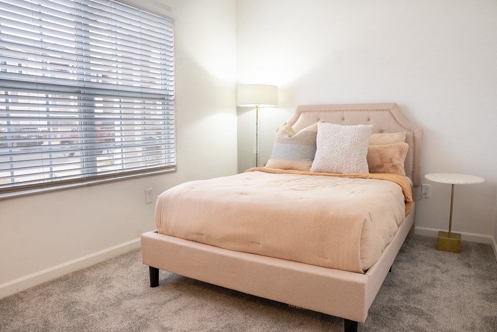 a bedroom with a bed and two windows  at Waterstone Landing, Perrysburg