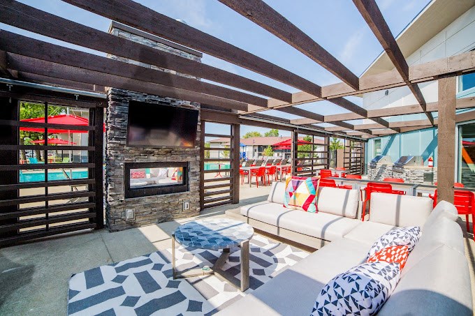 a patio with couches and a fireplace