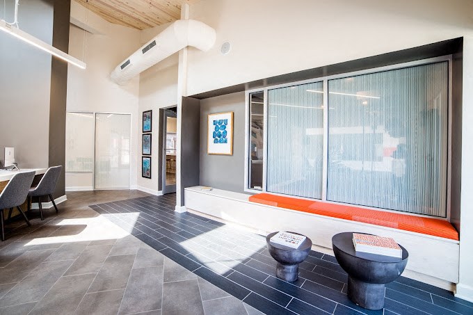 a room with a large window and two toilets