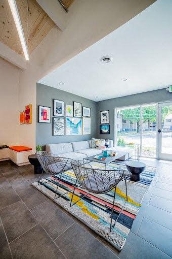 a living room filled with furniture and a large window