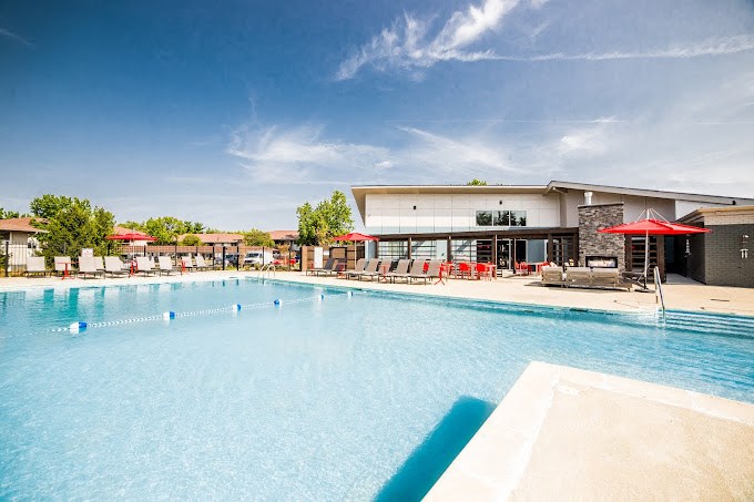 a large swimming pool with a building in the background
