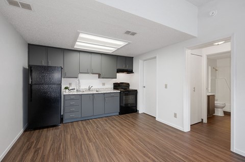 an empty kitchen with black appliances and a black refrigerator