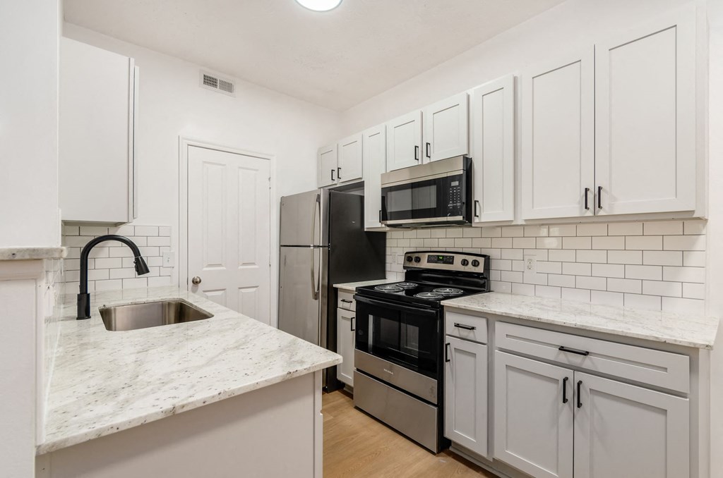 a kitchen with white cabinets and stainless steel appliances at Prescott Place, Ohio