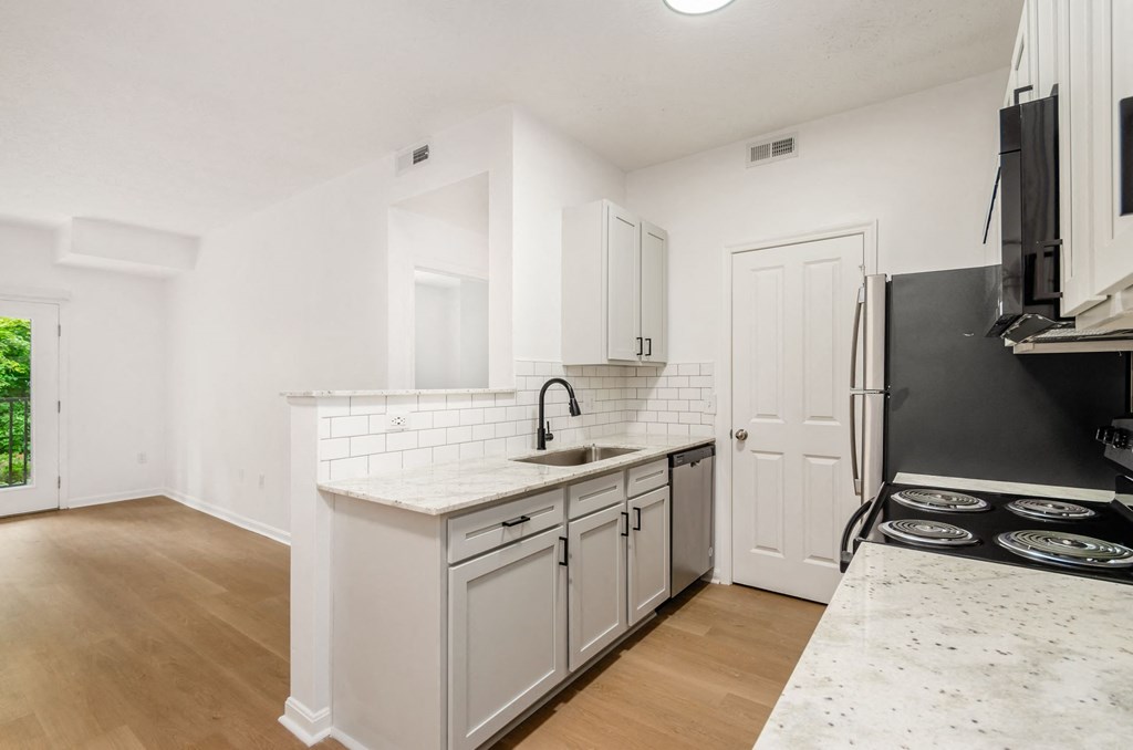 a renovated kitchen with white cabinets and a white counter top at Prescott Place, Columbus, OH