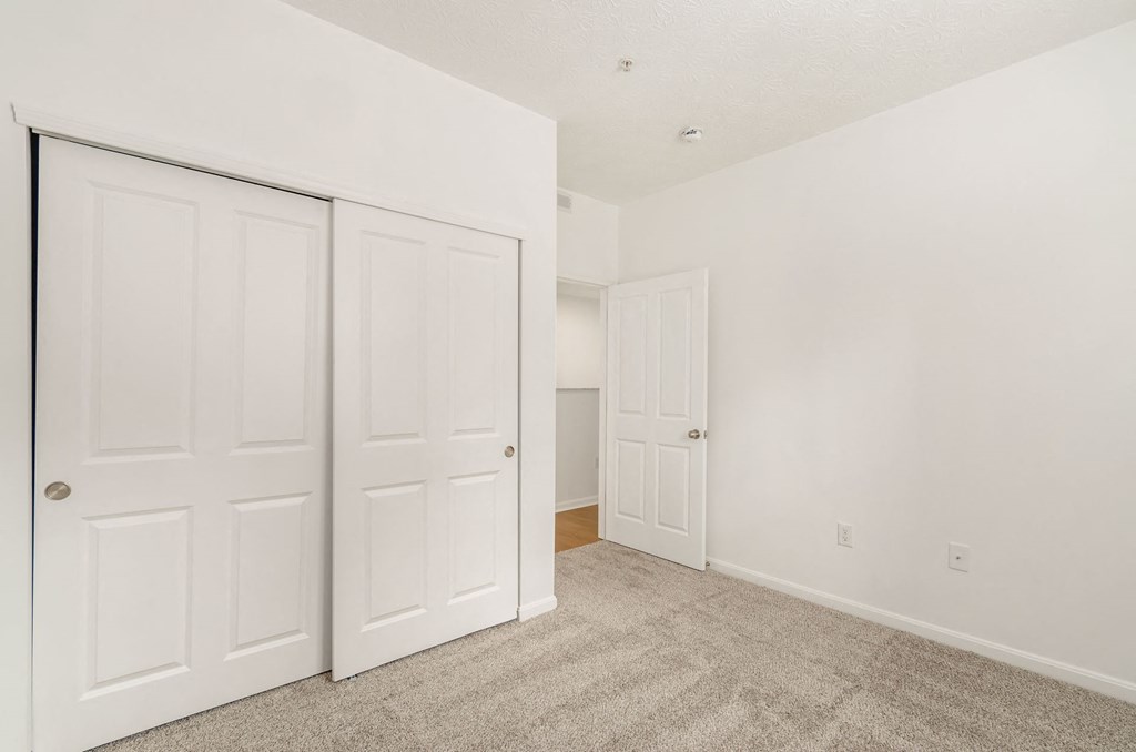 a bedroom with two closets and a carpeted floor at Prescott Place, Ohio, 43235