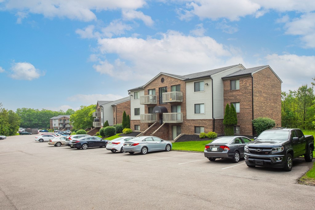 a parking lot with cars in front of an apartment building at The Woodridge Collection, Ohio, 45014