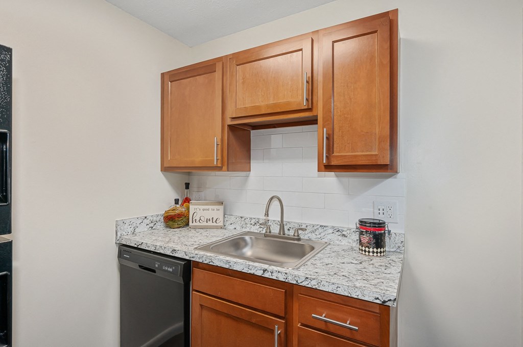 a kitchen with wood cabinets and granite countertops at The Woodridge Collection, Fairfield, 45014
