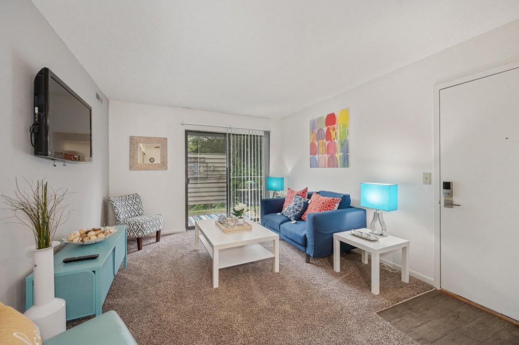 a living room with white walls and a blue couch at The Woodridge Collection, Ohio, 45014