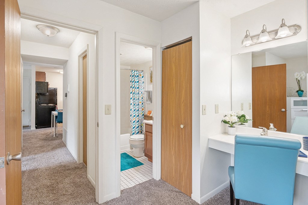 a hallway with two doors and a blue chair at The Woodridge Collection, Fairfield