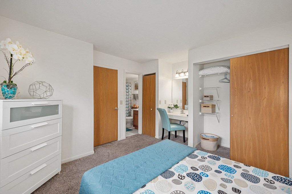 a bedroom with a bed and a desk in a room  at The Woodridge Collection, Fairfield, OH 45014