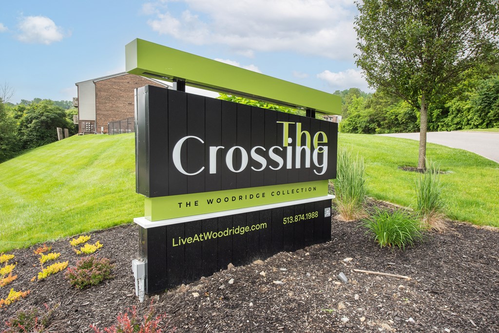 a sign for the crossing in front of a grass field at The Woodridge Collection, Ohio