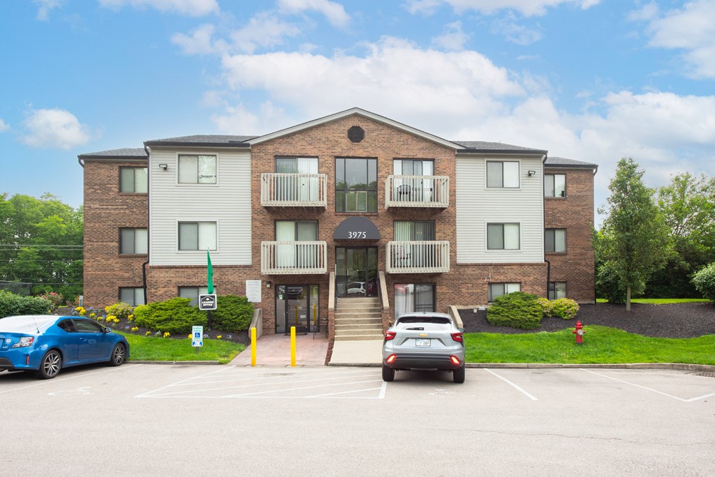a large apartment building with cars parked in front of it at The Woodridge Collection, Ohio, 45014