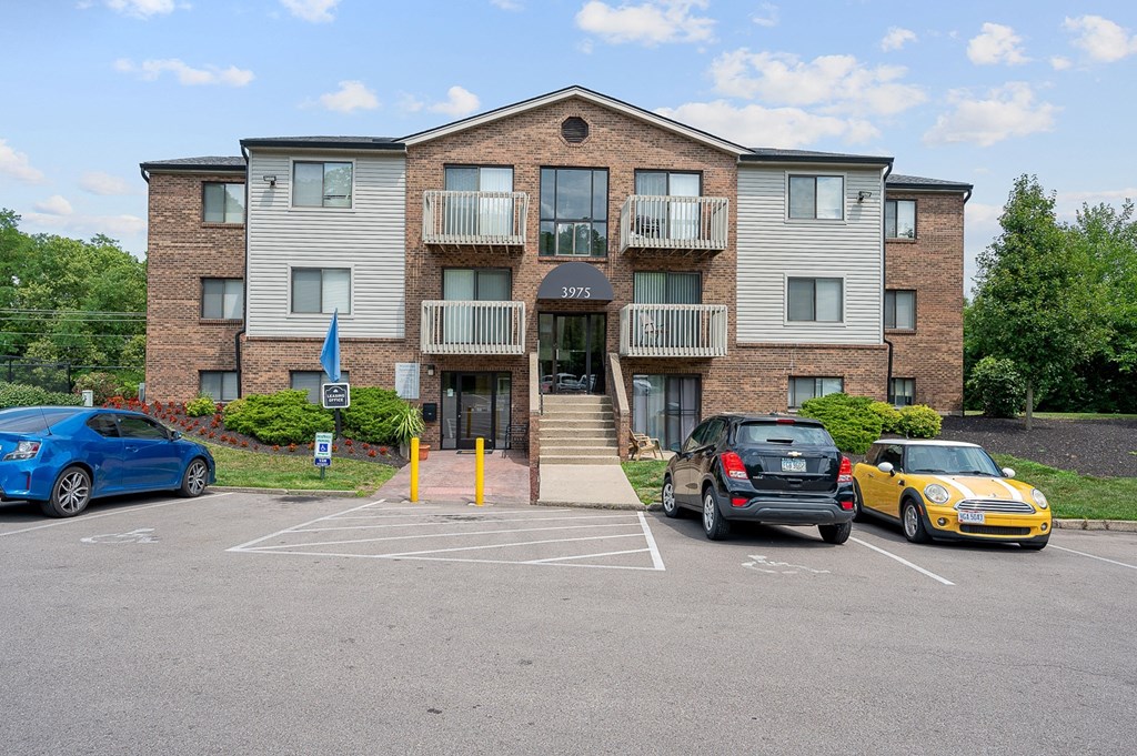 a large apartment building with a parking lot in front of it at The Woodridge Collection, Fairfield Ohio