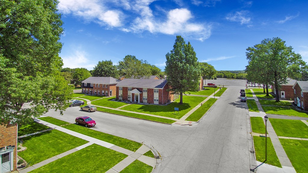 an aerial view of a neighborhood with houses and a street
