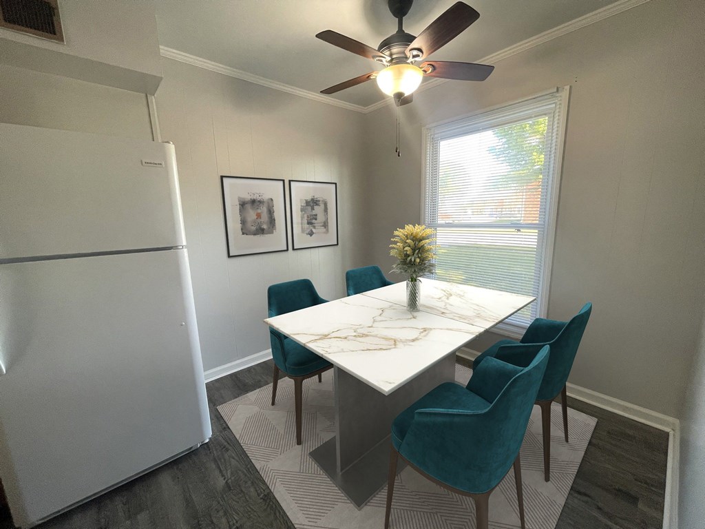 a dining room with a fridge and a ceiling fan