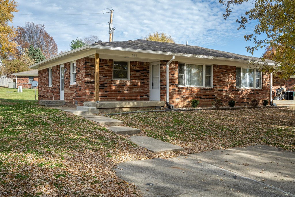 a small brick house with a sidewalk in front of it  at Stonebrook of Franklin, Franklin
