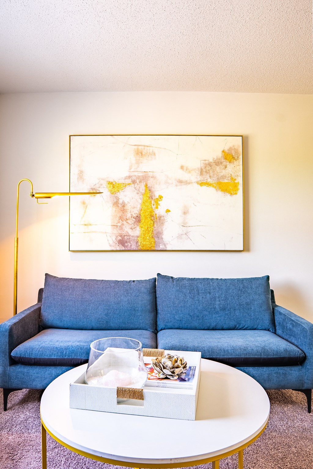 a living room with a blue couch and a coffee table