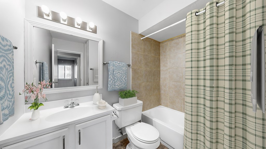 A bathroom with a white sink and a white toilet.