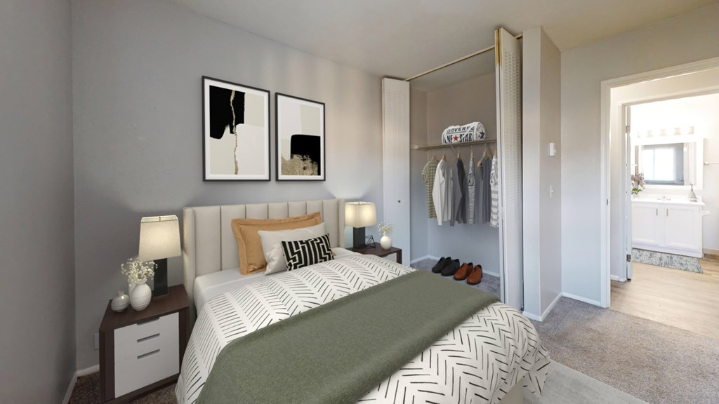 A bedroom with a bed, nightstands, and a wardrobe.