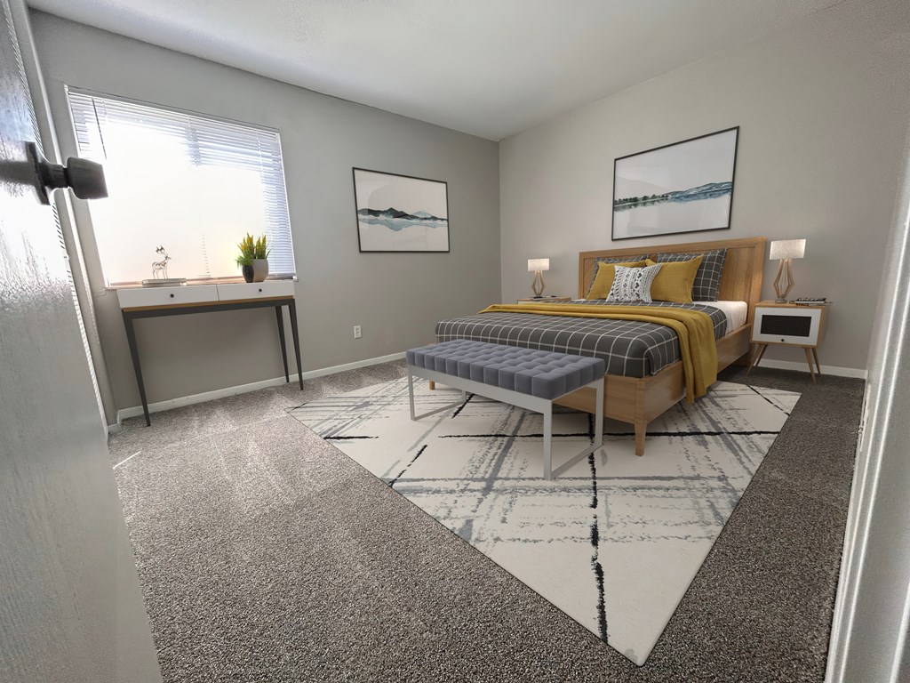 a bedroom with a bed and a desk and a window