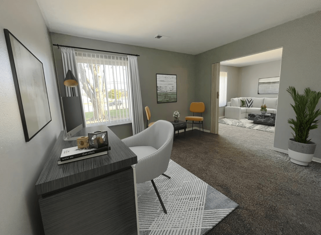 a living room with a couch and a chair in front of a window