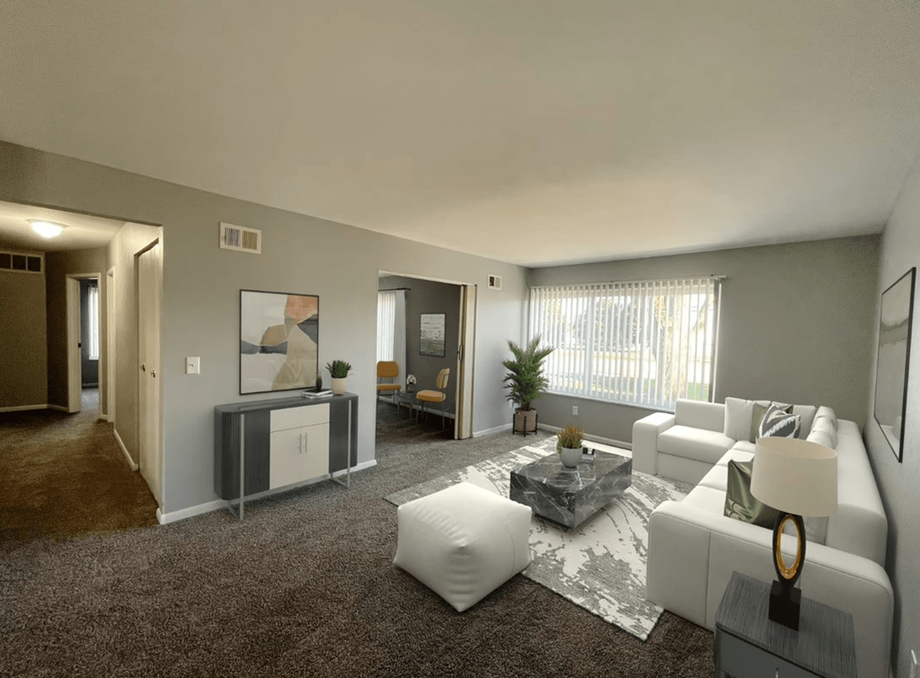 a living room with gray walls and brown carpet