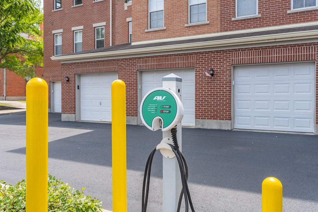 an electric car charging station in front of a brick building