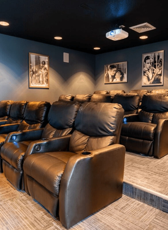 Home theater room with leather chairs and blue walls