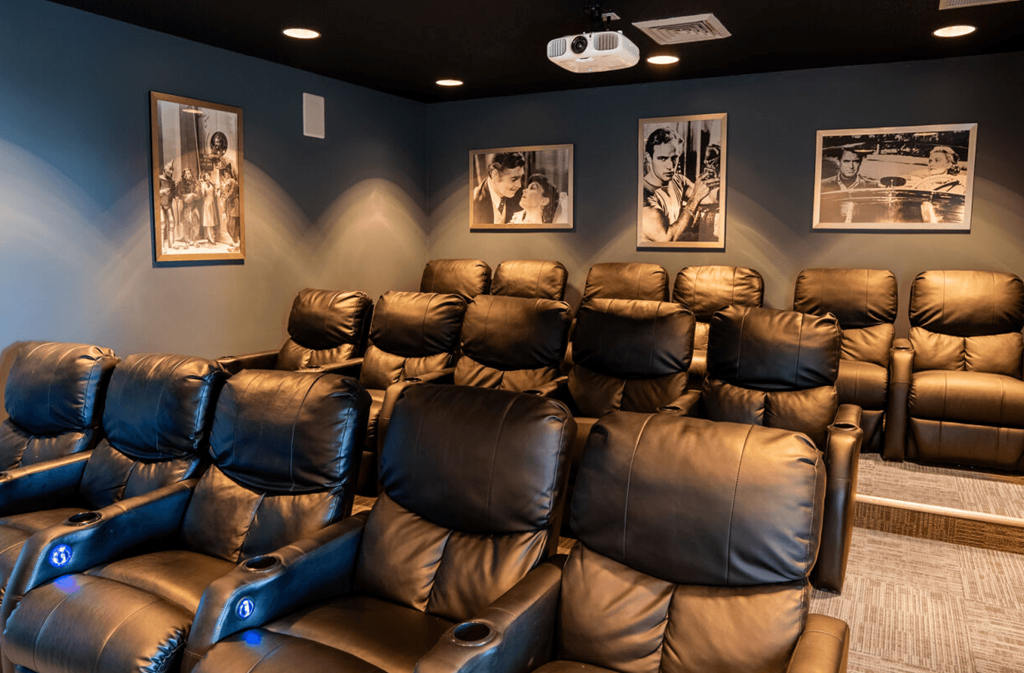 Home theater room with leather chairs and pictures on the wall